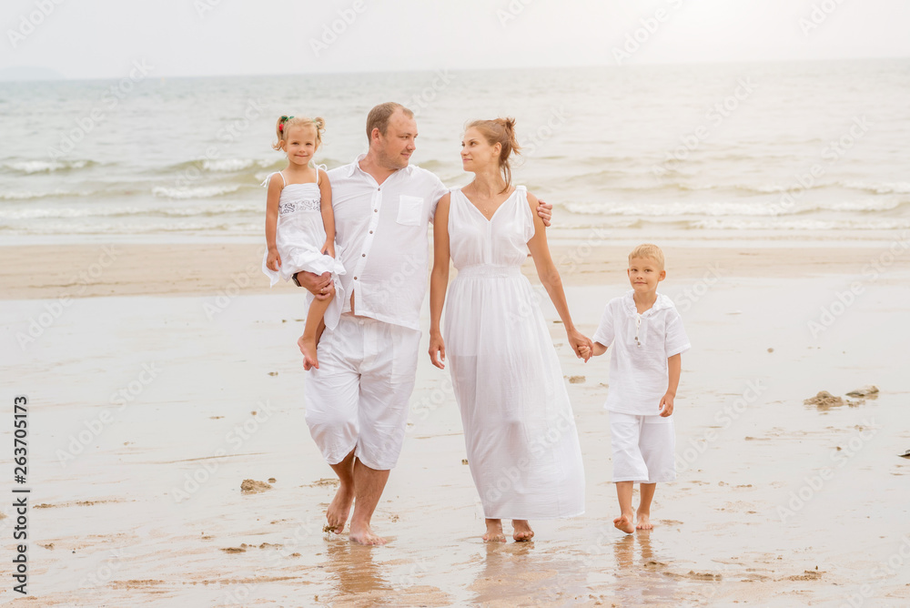 Happy young family on the sunset at the beach. Happy young family on the sunset at the beach.