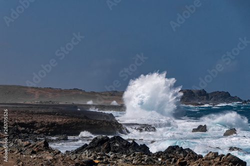Wind blowing the water and waves against the rocks on the beautiful coast