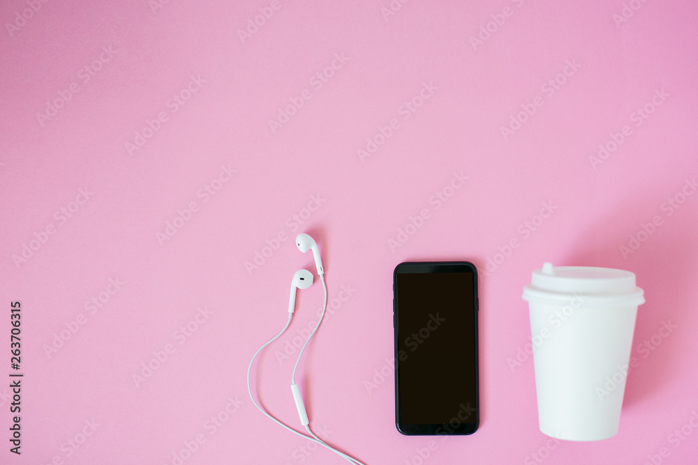 Top view of a smartphone with headphones and cup of coffee. Top view of a smartphone with headphones and cup of coffee.