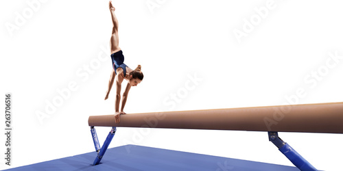 Female athlete doing a complicated exciting trick on gymnastics balance beam on white background. Isolated Girl perform stunt in bright sports clothes photo