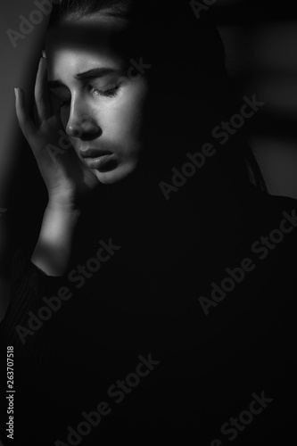 Portrait of a girl in shadows. Black and white