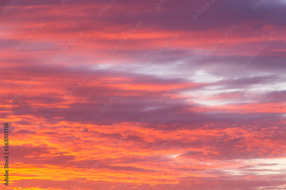 Beautiful soft dramatic sunrise orange pink sky with clouds