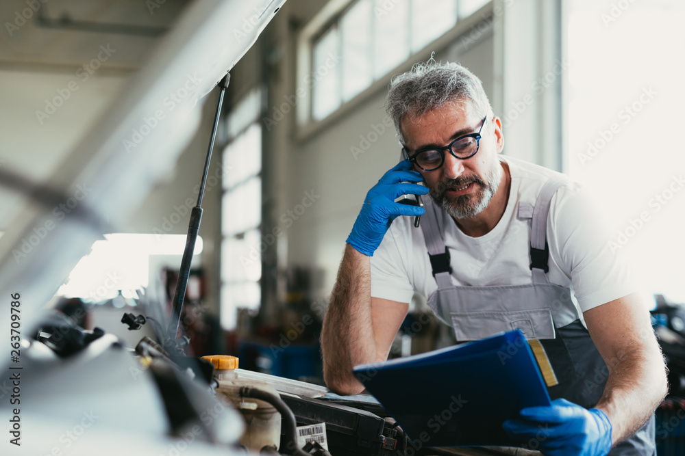 mechanic ordering car parts in car service mechanic ordering car parts in car service