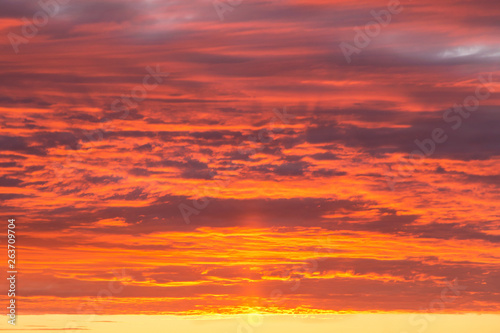 Epic dramatic sunset, sunrise orange sky with clouds and sunlight background texture © Viktor Iden