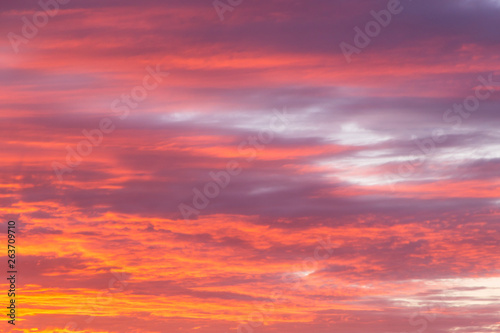 Beautiful soft dramatic sunrise orange pink sky with clouds background texture © Viktor Iden