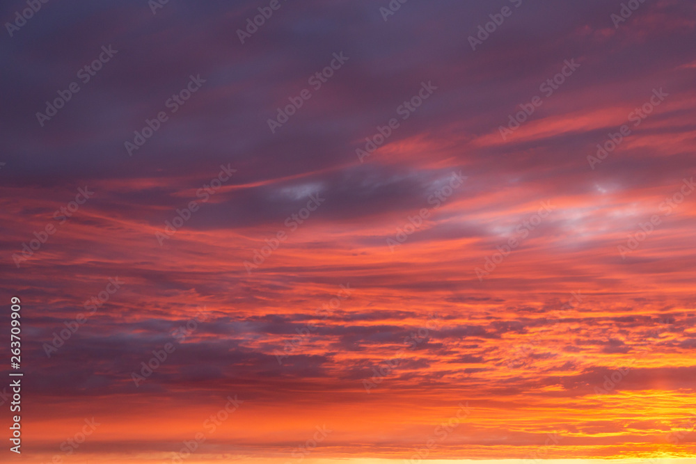 Dramatic epic sunset orange pink sky with clouds background texture