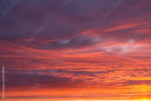 Dramatic epic sunset orange pink sky with clouds background texture