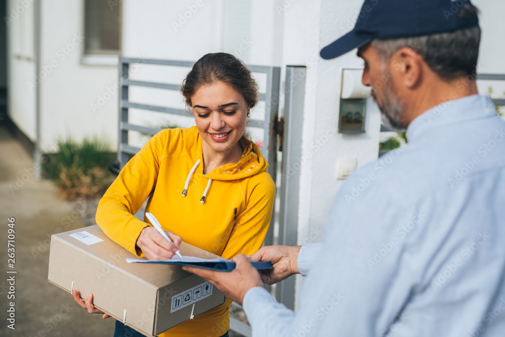 woman signing for package delivery woman signing for package delivery