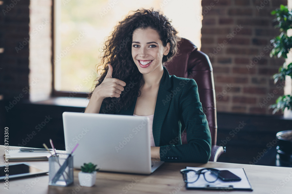 Fototapeta premium Portrait of satisfied pretty cute ceo clever intelligent with long curly hair make advert concept decision advice choice recommendation sit armchair wooden table have modern blazer gadget industrial