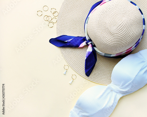 Composition of woman swimsuit,hat and fachion accesories on biege background,flat lay,top view. Travel concept.