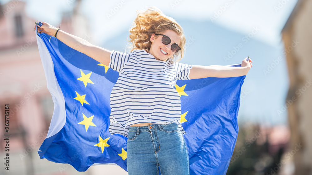 Attractive happy young girl with the flag of the European Union - obrazy, fototapety, plakaty 