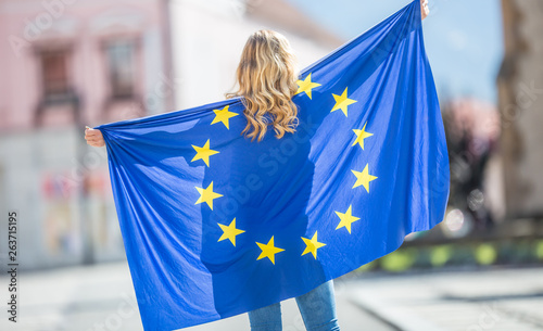Attractive happy young girl with the flag of the European Union
