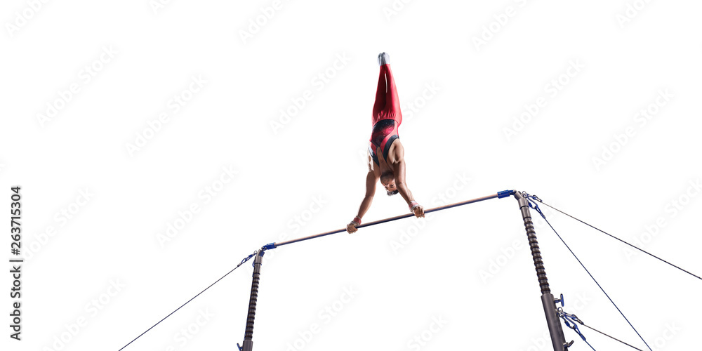 Male athlete doing a complicated exciting trick on horizontal gymnastics bars on white background. Isolated Man perform stunt in bright sports clothes