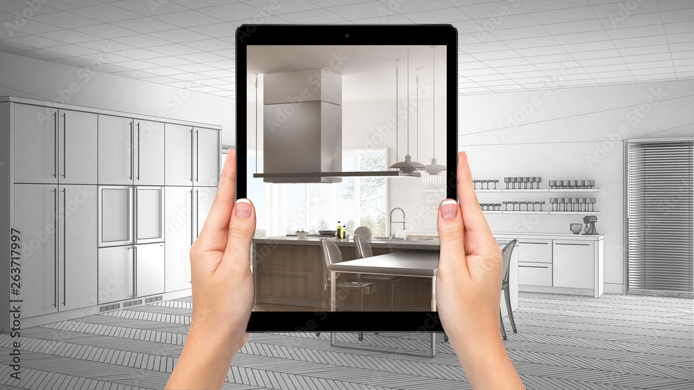 Hands holding tablet showing modern white and wooden kitchen. Blueprint CAD sketch background, augmented reality concept, application to simulate furniture and interior design products Hands holding tablet showing modern white and wooden kitchen. Blueprint CAD sketch background, augmented reality concept, application to simulate furniture and interior design products