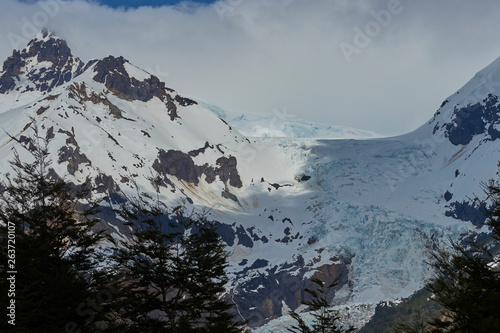 Glacier flowing over the edge of the mountains along the Carretera Austral as it passes Lago Yelcho in southern Chile 