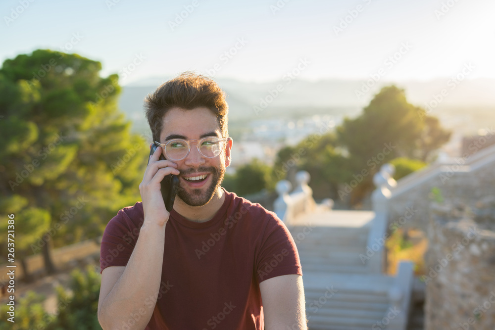 young man talking on the mobile phone young man talking on the mobile phone