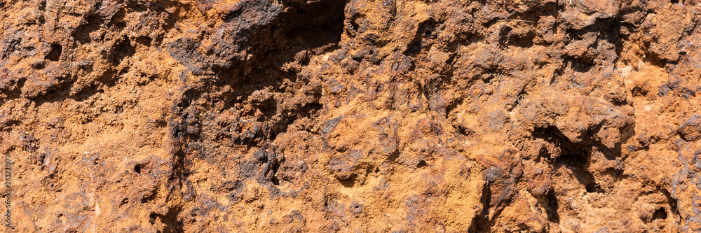 Natural volcanic stone in red and brown. Surface of the volcanic rock. Panoramic image Natural volcanic stone in red and brown. Surface of the volcanic rock. Panoramic image
