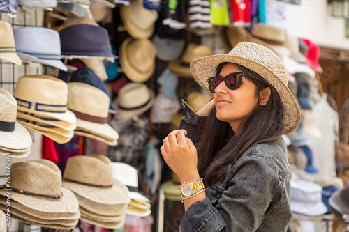 Young indian woman buying hats