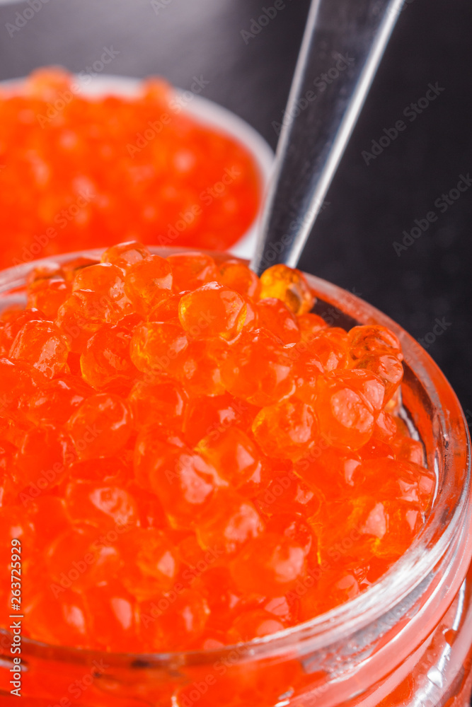 red caviar in a bowl on a dark stone background red caviar in a bowl on a dark stone background