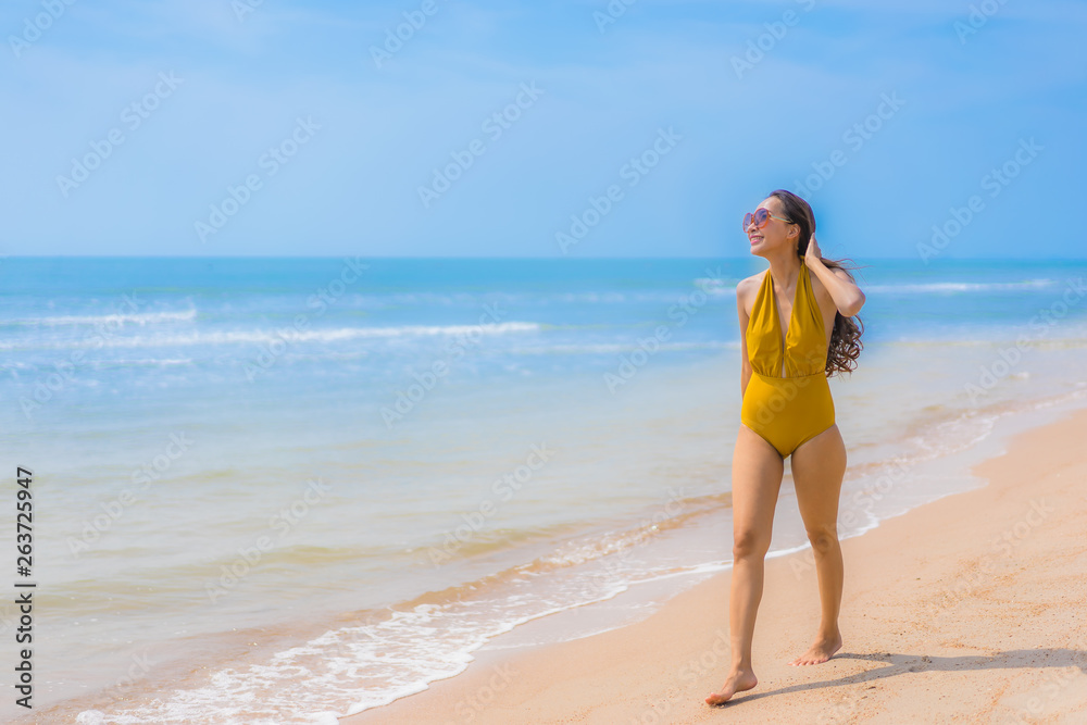 Portrait beautiful young asian woman smile happy on the beach and sea