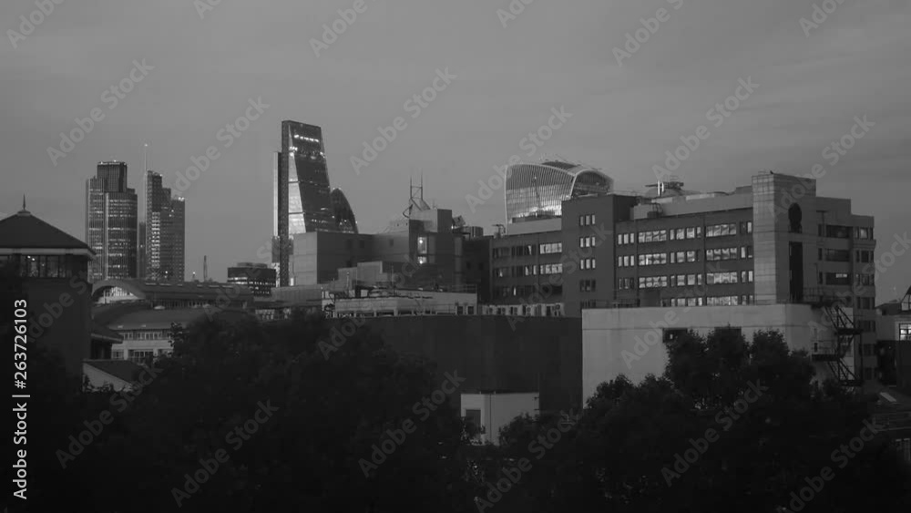 Elevated view over London City financial district skyline at sunset black and white establishing shot Elevated view over London City financial district skyline at sunset black and white establishing shot
