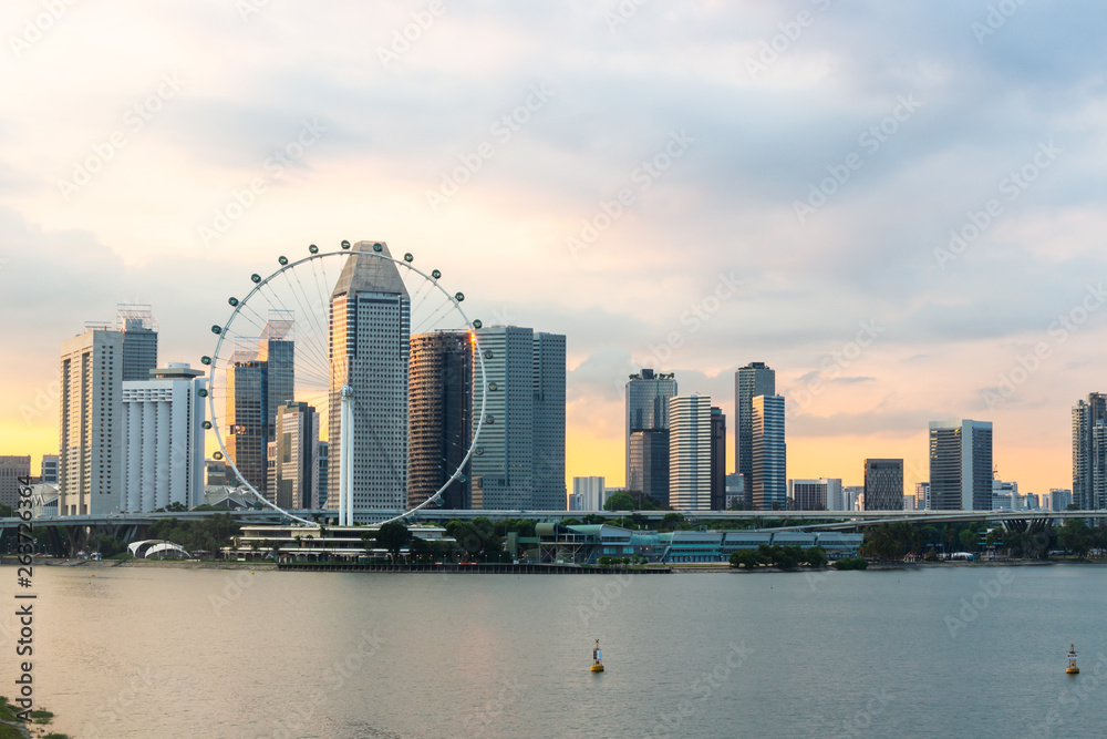 Obraz premium Singapore flyer cityscape on marina bay and sunset in twilight time . Taken photo from marina barrage .