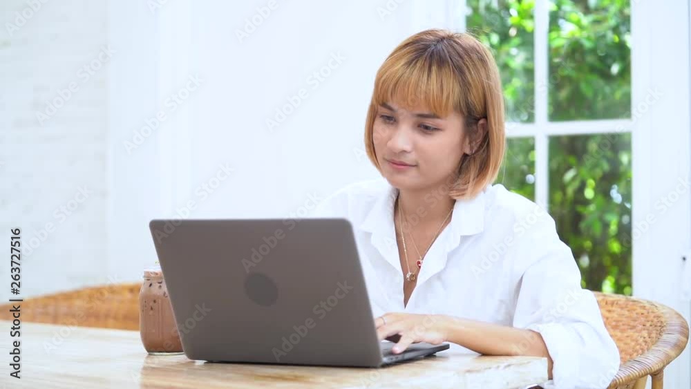 Asian businesswoman working on laptop in her workstation. Asian businesswoman working on laptop in her workstation.