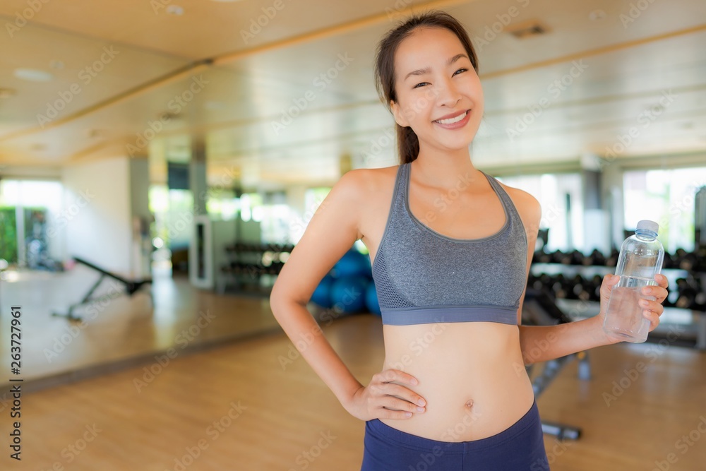Portrait beautiful young asian woman with bottle water in gym Portrait beautiful young asian woman with bottle water in gym