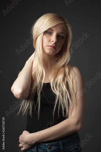 Attractive blonde girl on gray background