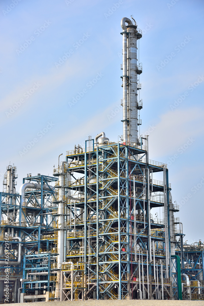 Close-up of pipelines and destillation tanks of an oil-refinery plant Close-up of pipelines and destillation tanks of an oil-refinery plant
