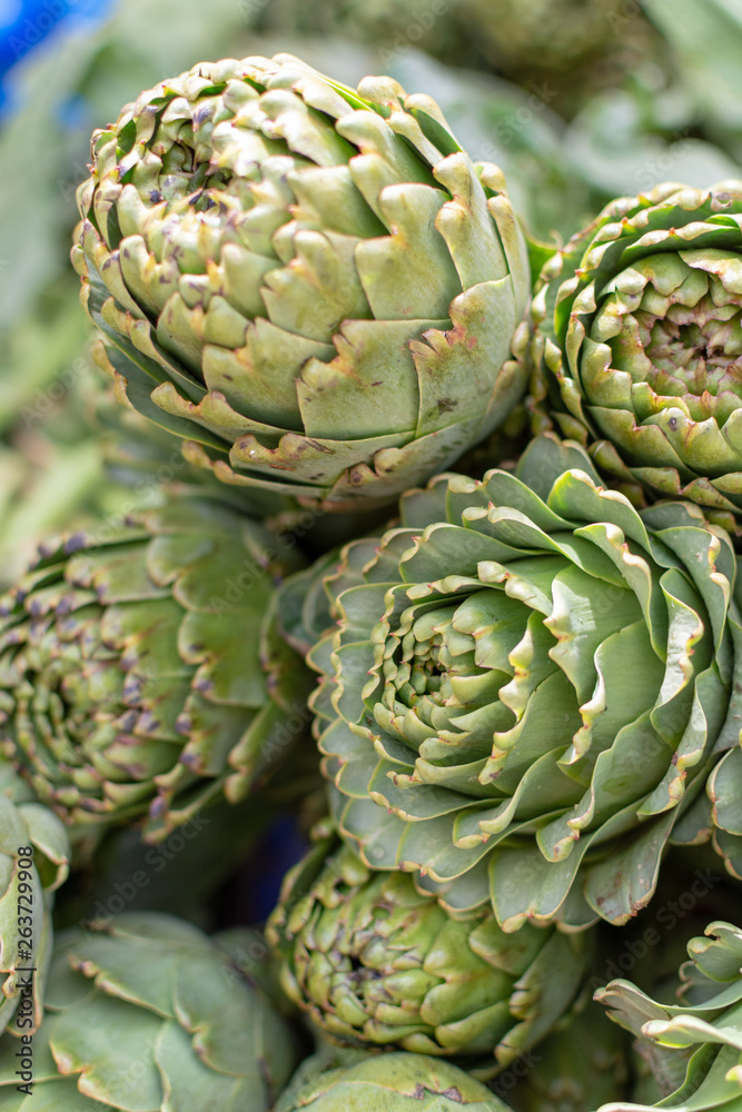 Fototapeta premium Bunch of fresh raw artichokes heads from artichoke plantation in Argolida, Greece on argicultural market in Nafplio