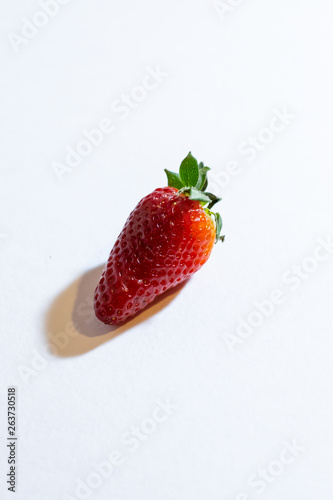 Fresh strawberry berries on a white background. Vertical orientation