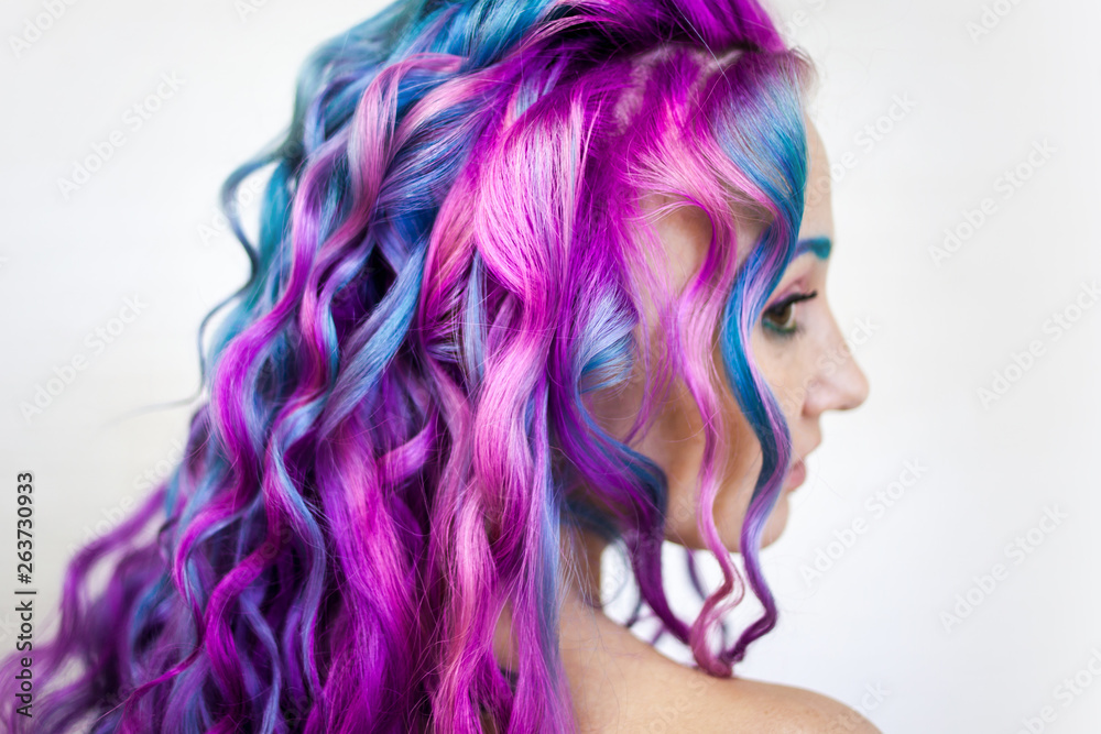 Bright multi-colored hair coloring, gradient blue purple and pink shades. Beautiful hair