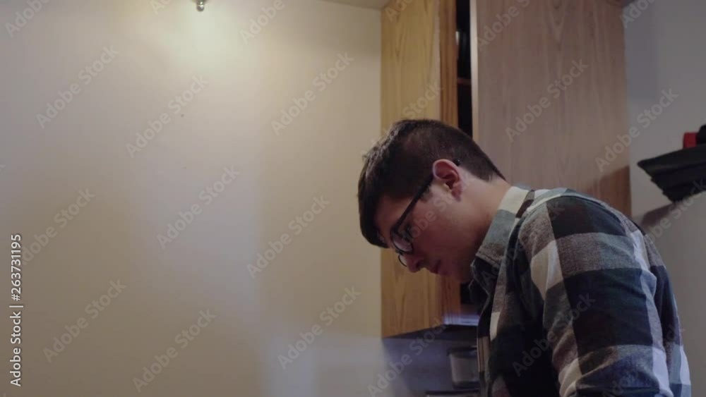 Person in the kitchen. Shallow depth of field. 24 fps. Slow pan to the left. Person in the kitchen. Shallow depth of field. 24 fps. Slow pan to the left.