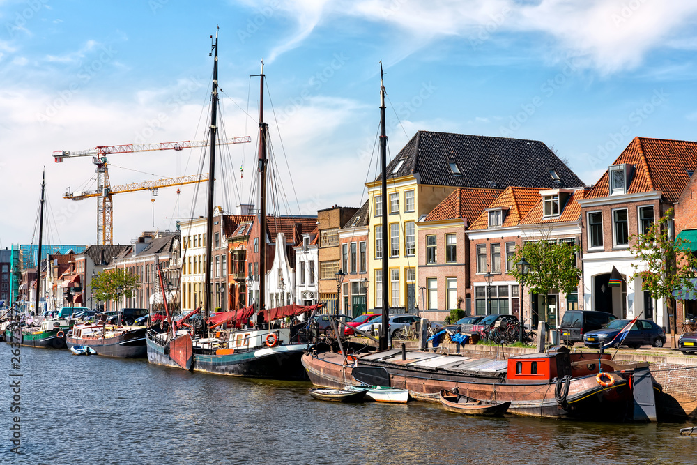 Canal with old ships and historical houses in Zwolle, Netherlands
