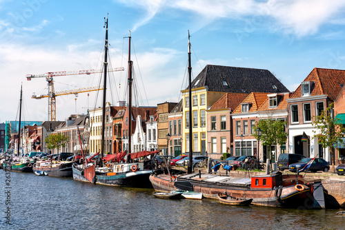 Canal with old ships and historical houses in Zwolle, Netherlands photo