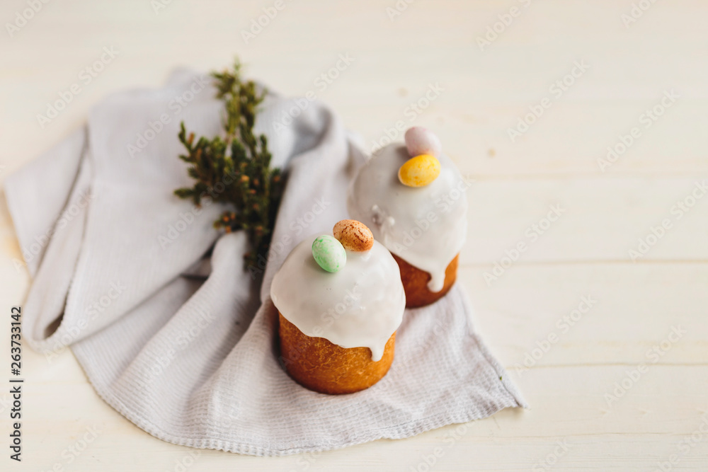 Obraz premium Happy Easter background with an easter bread cake decorated with glaze, chocolate and eggs. For greeting card, ad, promotion, poster, flyer. complex composition, beautiful scenery, movement, hands