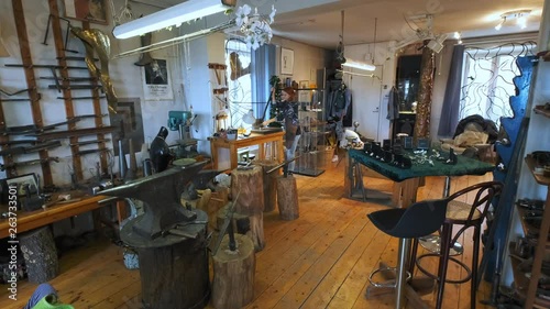 A silversmith working hard in her workshop. photo