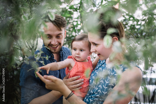 Family enjoy a moment together looking at leaves