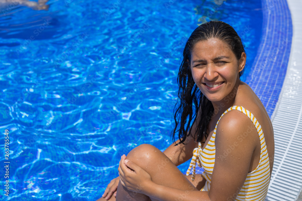 Young indian woman happy in the pool