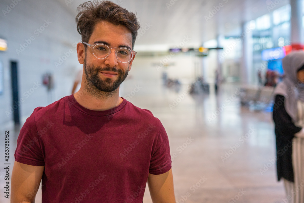 young man happy and laughing in the airport