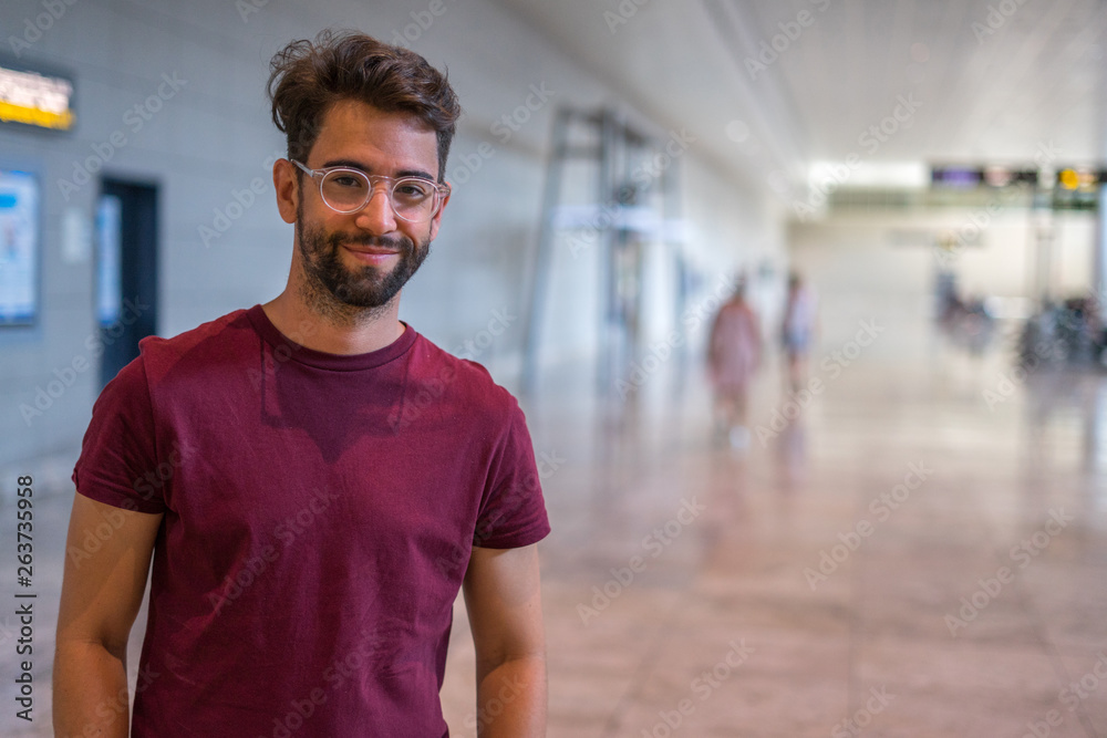 Young man happy and laughing in the airport Young man happy and laughing in the airport