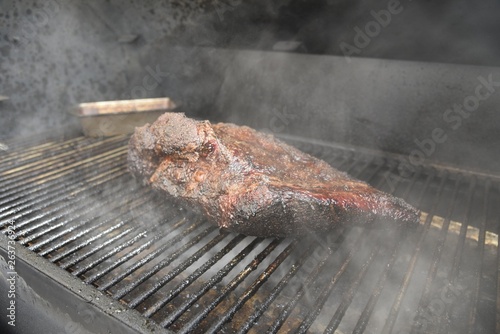 beef brisket cooking in smoker