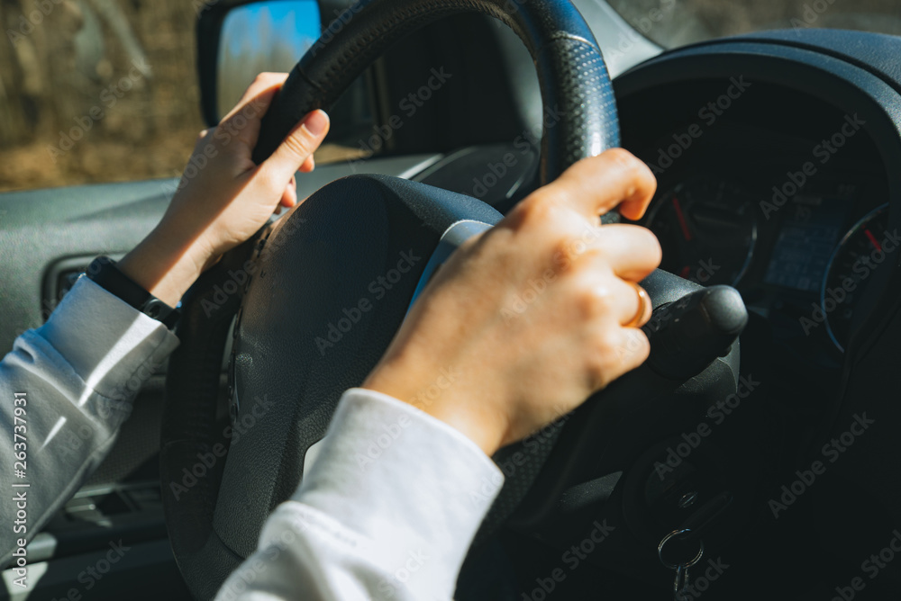 woman hands on steering wheel. car travel concept