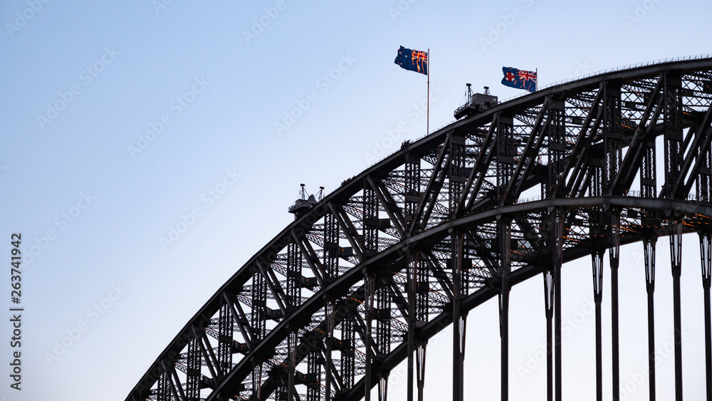 Closeup of the top of Sydney Harbour Bridge with waving Australian flags Closeup of the top of Sydney Harbour Bridge with waving Australian flags