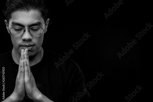 mexican young man praying black and white 