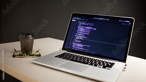 Programmer's workplace, laptop with project code. Development of websites and applications