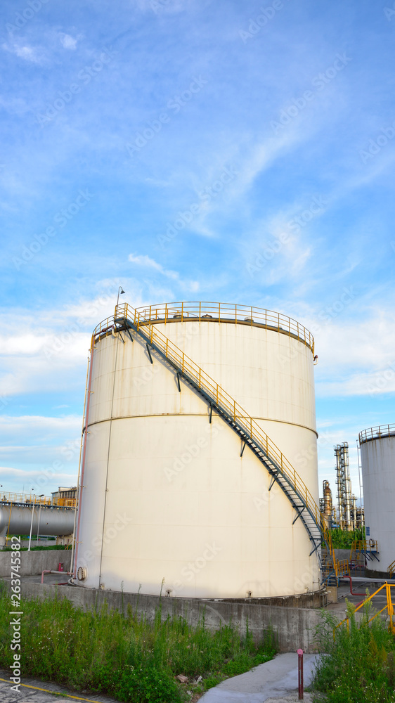 White ethanol, alcohol, the background of the blue sky white cloud of industrial storage tank of petrol and petroleum White ethanol, alcohol, the background of the blue sky white cloud of industrial storage tank of petrol and petroleum