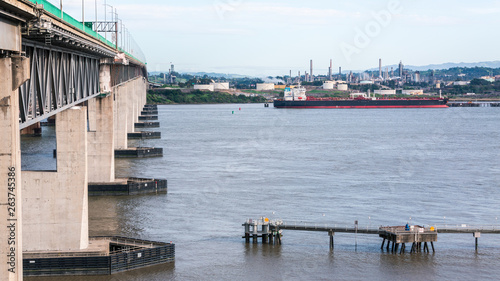 Benicia California. An oil tanker unloads into refinery.