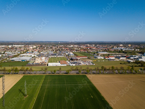 Aerial drone view of Haunstetten, a suburb of Augsburg in Germany. View over the federal Highway B17 towards the commercial and industrial district of Haunstetten.